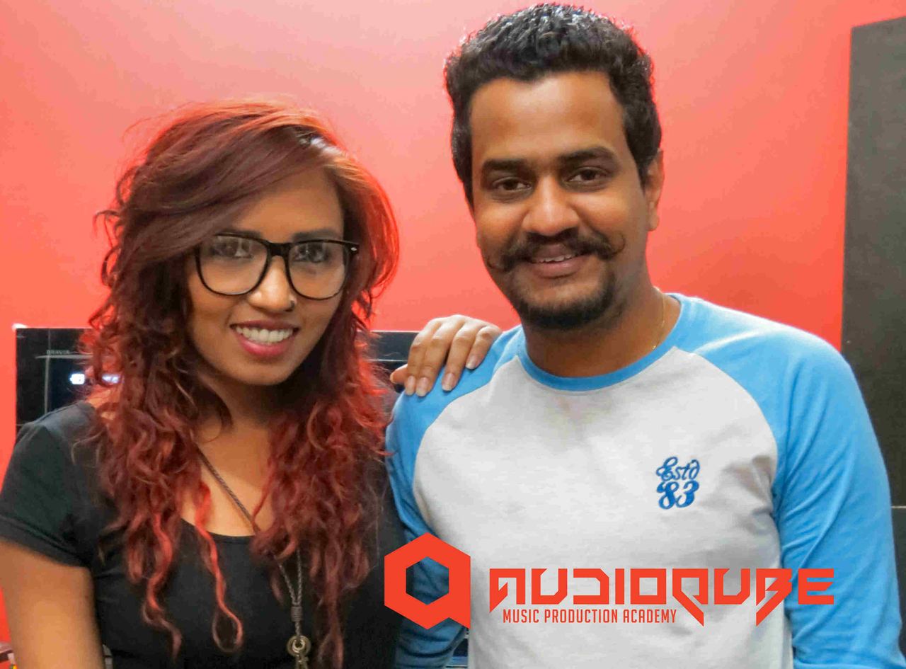 Audioqube DJ faculty posing with Sound Avtar in front of the Audioqube logo